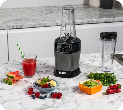 Ninja personal blender with smoothie cup and ingredients on a countertop